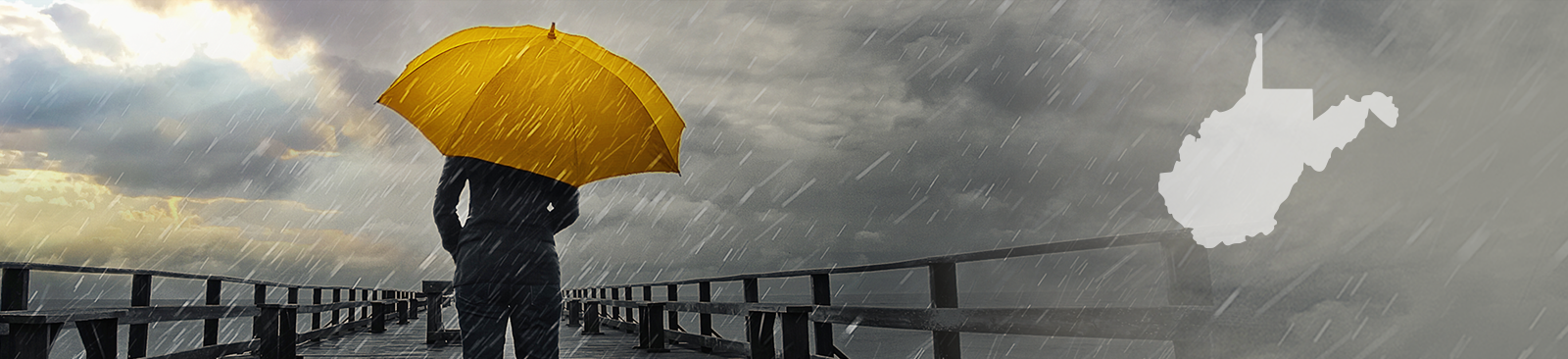 A person stands with their back to the camera, carrying a bright yellow umbrella in the middle of a storm. They stand on a pier, looking out at the stormy sky, which simultaneously looks threatening and hopeful as some of the clouds part to reveal a glimpse of sunshine.